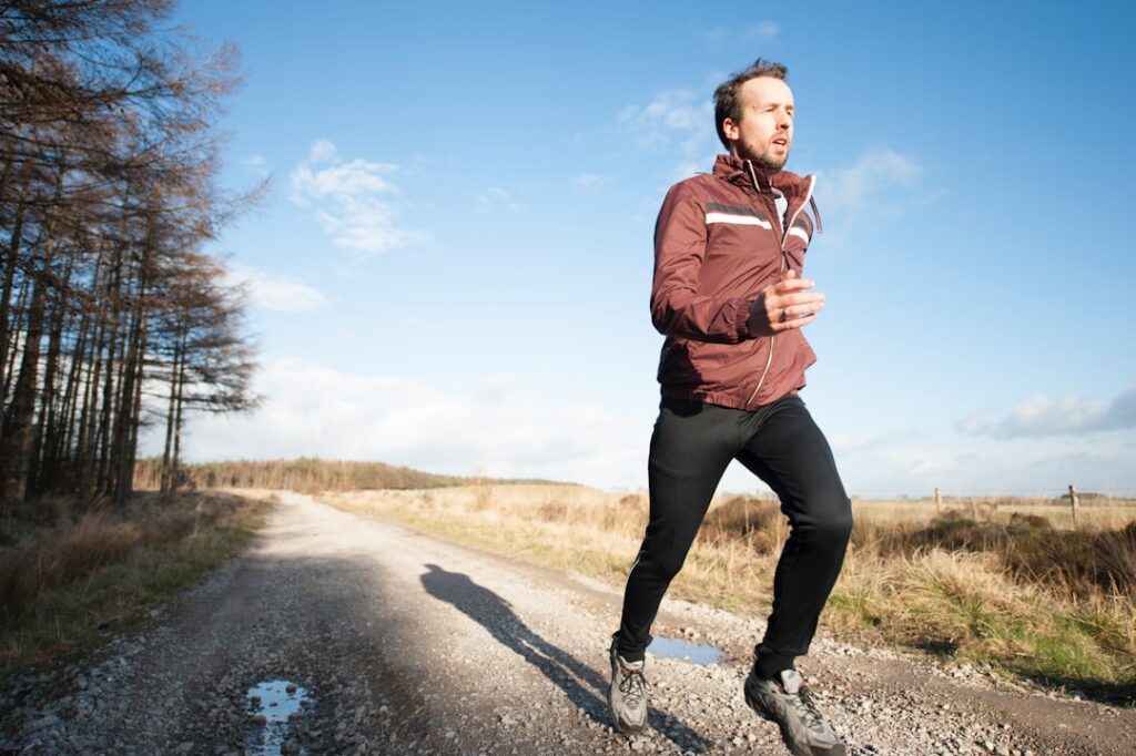 A runner completing a successful training session looking happy and strong possibly celebrating a milestone