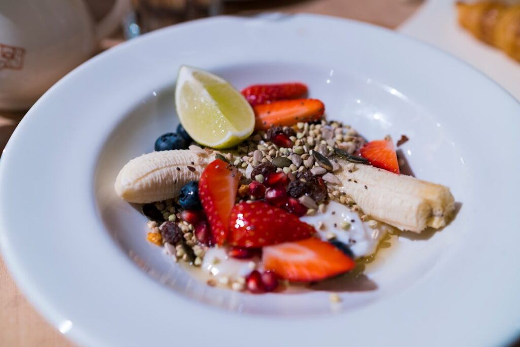 A beautiful bowl of Greek yogurt topped with fresh mixed berries strawberries blueberries raspberries and a drizzle of h