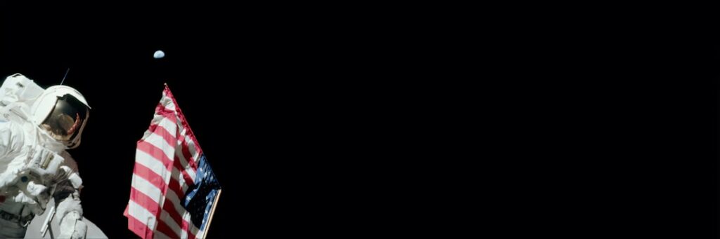 An astronaut planting a flag on the moon with the Earth visible in the background symbolizing the historic moon landing