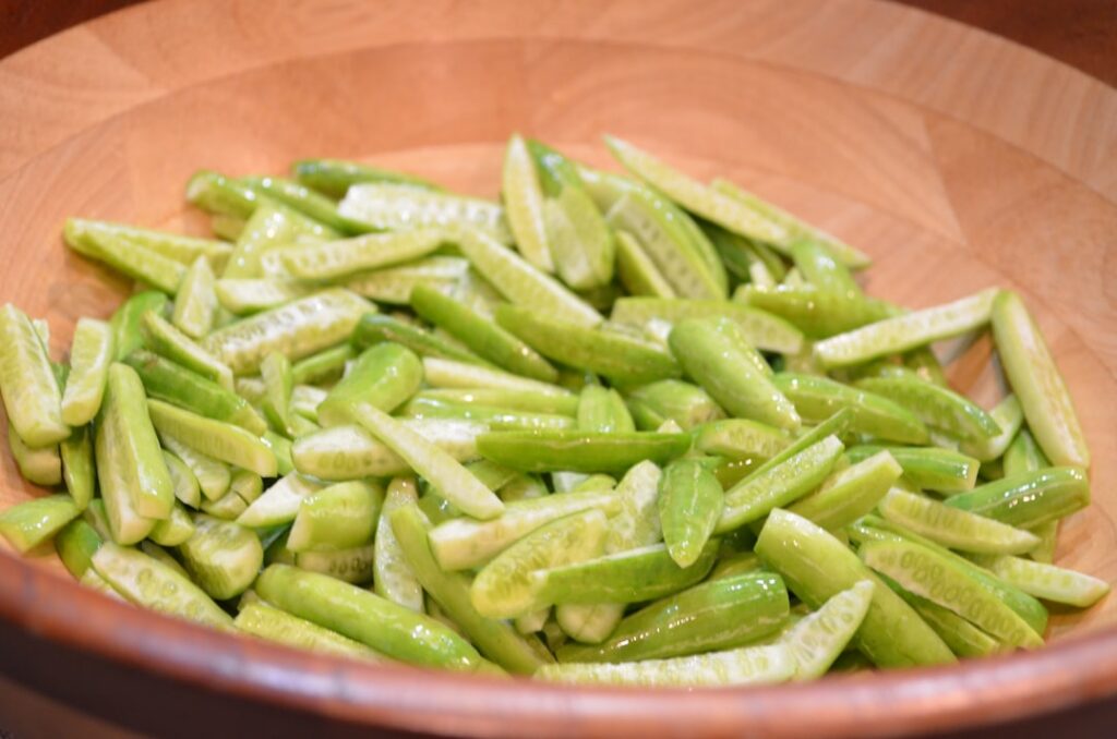 Freshly chopped okra pods simmering in a small saucepan with distilled water creating a clear slightly viscous liquid A 