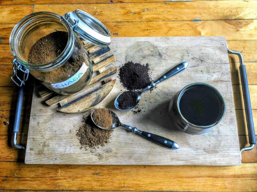 A close-up of a homemade coffee face cream being whisked in a glass bowl showing its creamy fluffy texture with a spatul