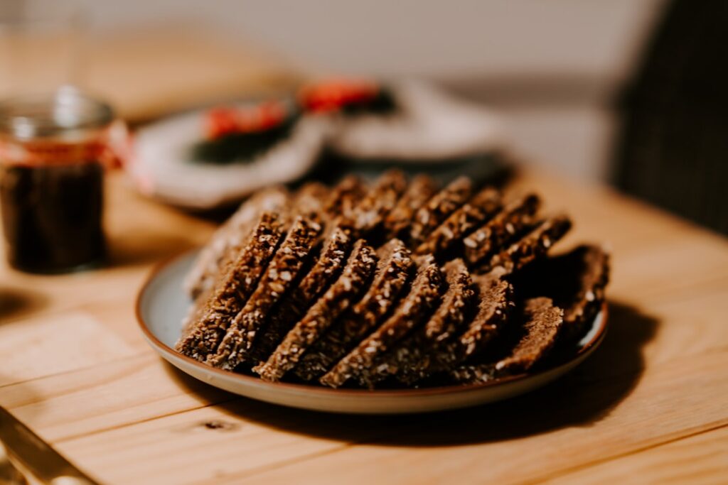 A close-up shot of a stack of freshly baked vegan breakfast cookies on a plate possibly with a few oats or nuts visible 
