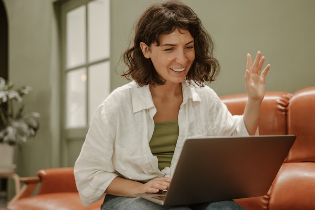 A person happily completing a quiz on a tablet or laptop with a thought bubble showing correctly spelled words indicatin