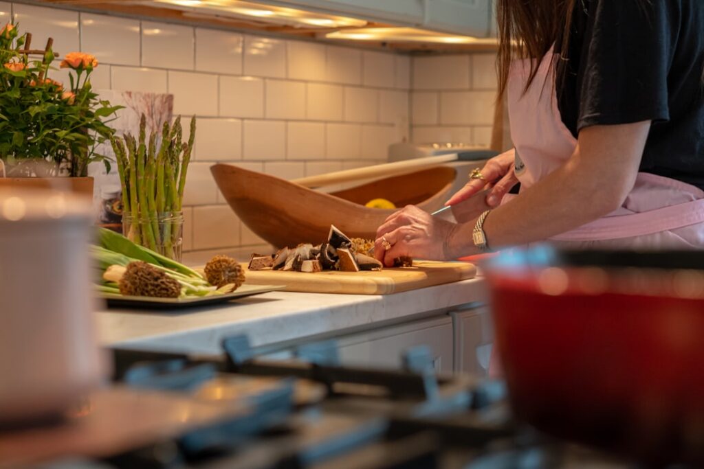 A person preparing a quick and healthy vegan breakfast in their kitchen showing ingredients like oats nuts and fresh fru