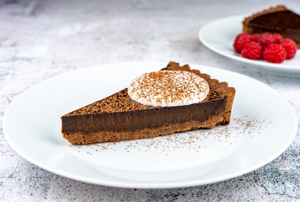 A perfectly sliced No-Bake Mocha Tart on a beautiful plate showing its creamy layers and a rich chocolate-coffee color G