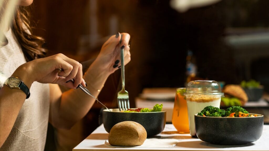 A person preparing a healthy high-protein meal in a clean modern kitchen showing ingredients like chicken breast fresh v