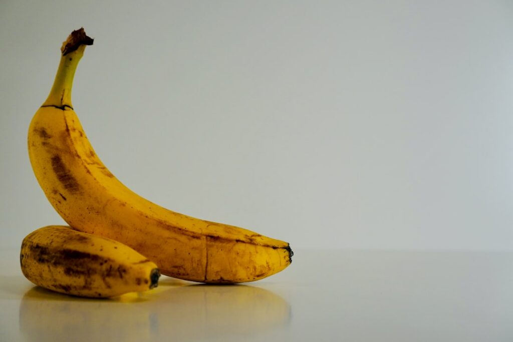A visual comparison chart showing the nutritional breakdown of a banana versus dates specifically highlighting sugar con