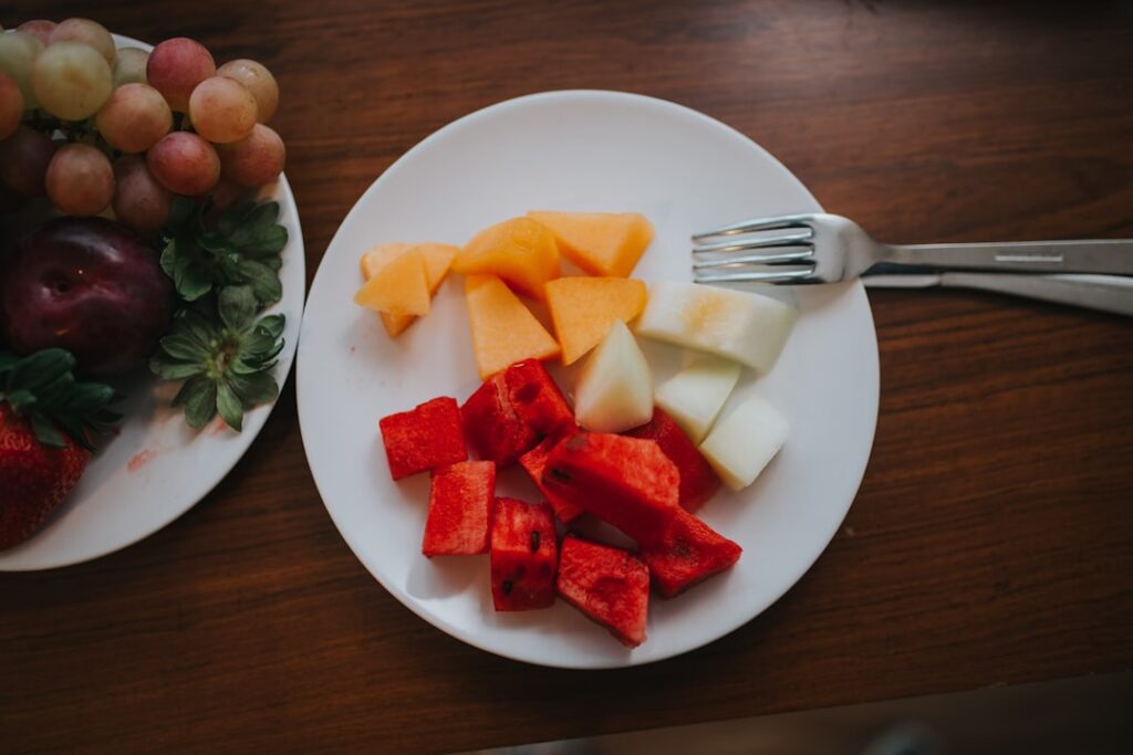 A vibrant and colorful spread of various fresh fruits vegetables herbs and whole grains arranged beautifully on a rustic