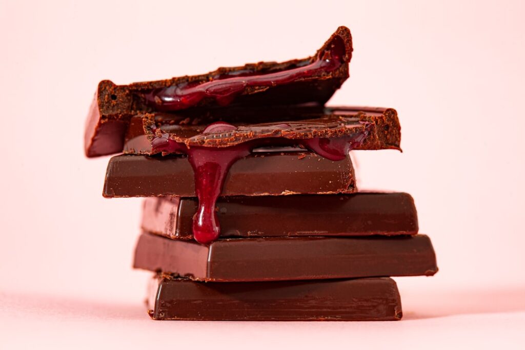A side-by-side comparison image of a milk chocolate bar and a dark chocolate bar visually contrasting their color textur