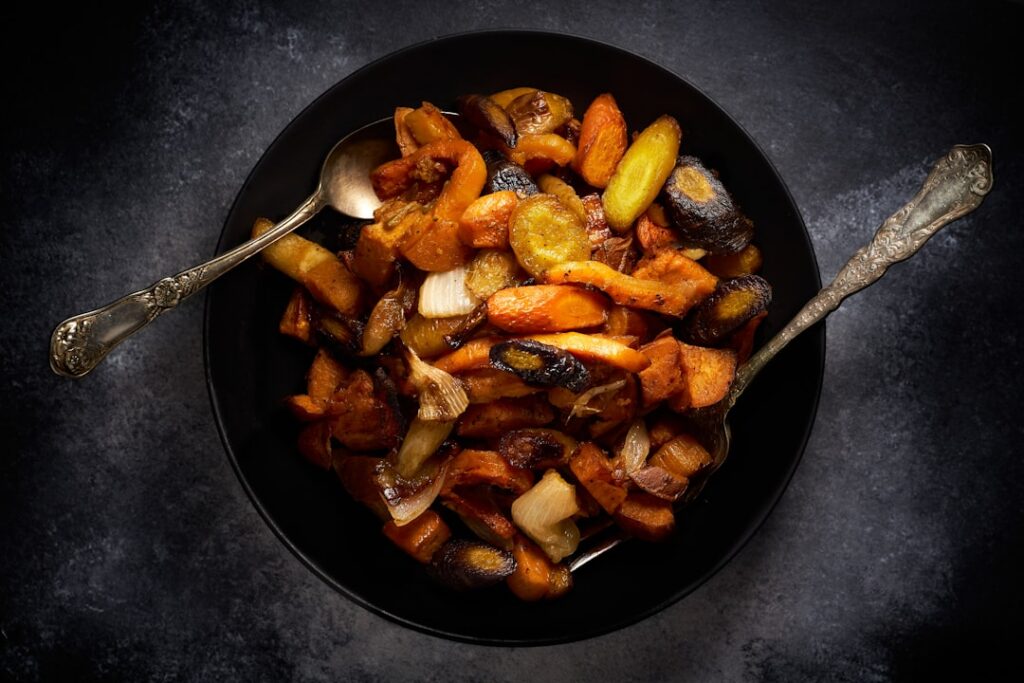 A delicious and healthy vegan meal featuring both roasted pumpkin and small baked potatoes as part of a balanced plate w