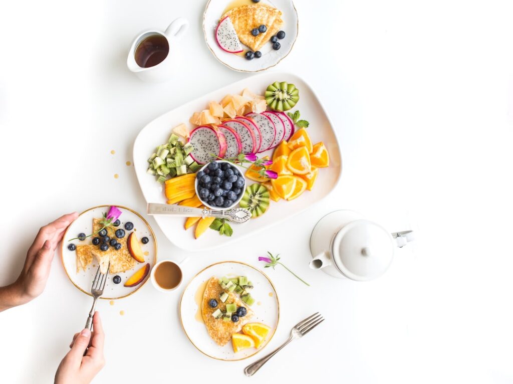 A vibrant and colorful platter of fresh fruits vegetables and herbs known for liver support such as leafy greens citrus 