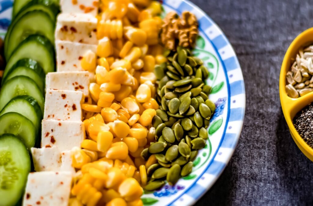 A variety of high-protein foods laid out such as chicken breast eggs Greek yogurt lentils and protein shakes perhaps wit