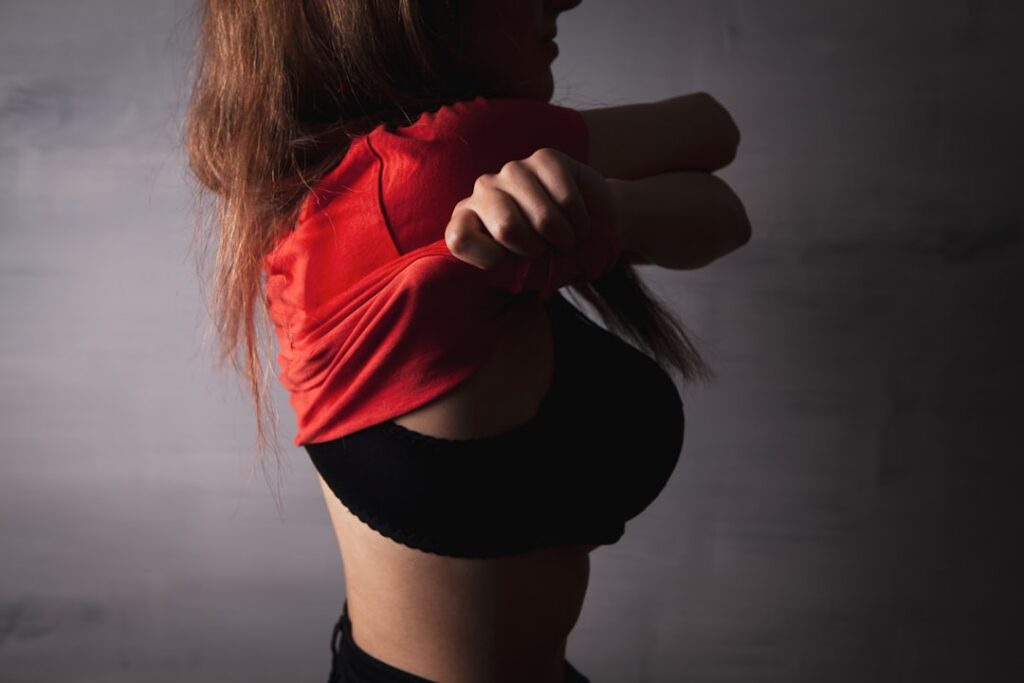 A person demonstrating proper form for a bodyweight squat viewed from the side showing the hips back and chest up