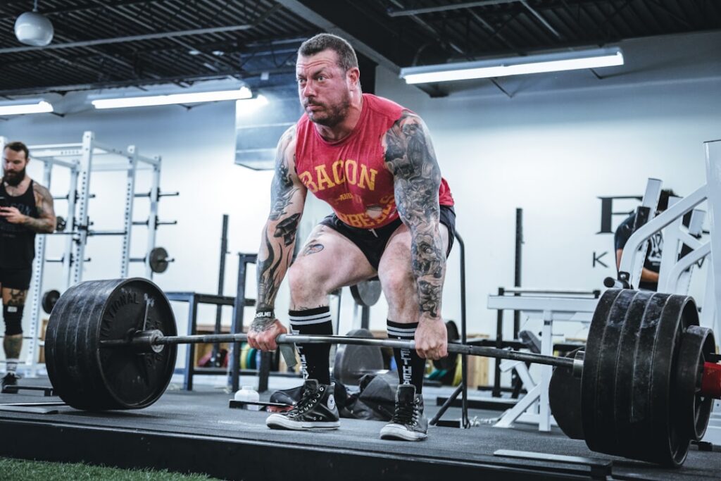 A person demonstrating a sumo squat highlighting the wide stance and outward-pointing toes