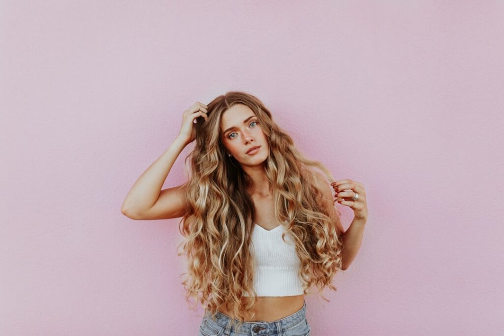 A woman with visibly thick healthy and shiny hair possibly with a subtle before-and-after comparison or just showcasing 