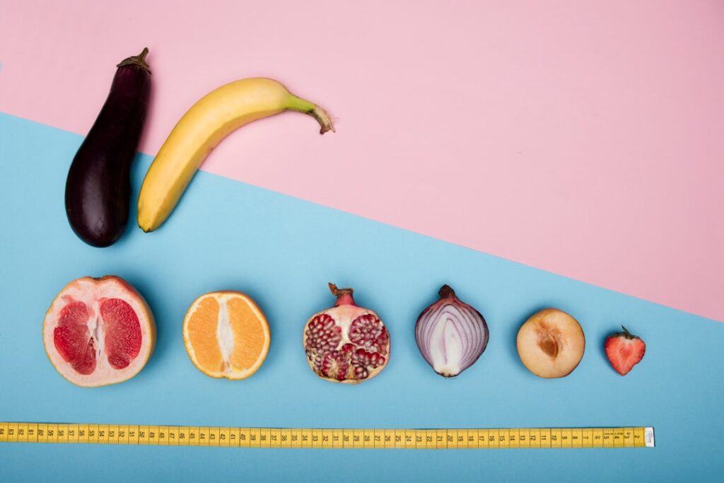 A vibrant colorful spread of various low-calorie fruits like berries watermelon slices apples and citrus fruits on a lig