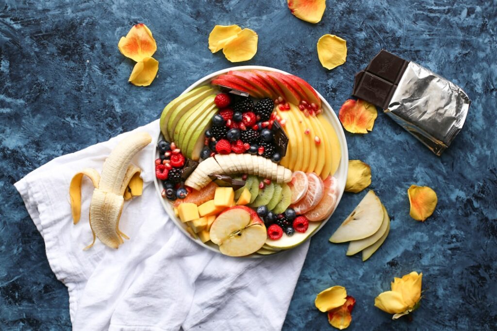 An infographic showing different common fruits with their approximate portion sizes that equal 100 calories For example 