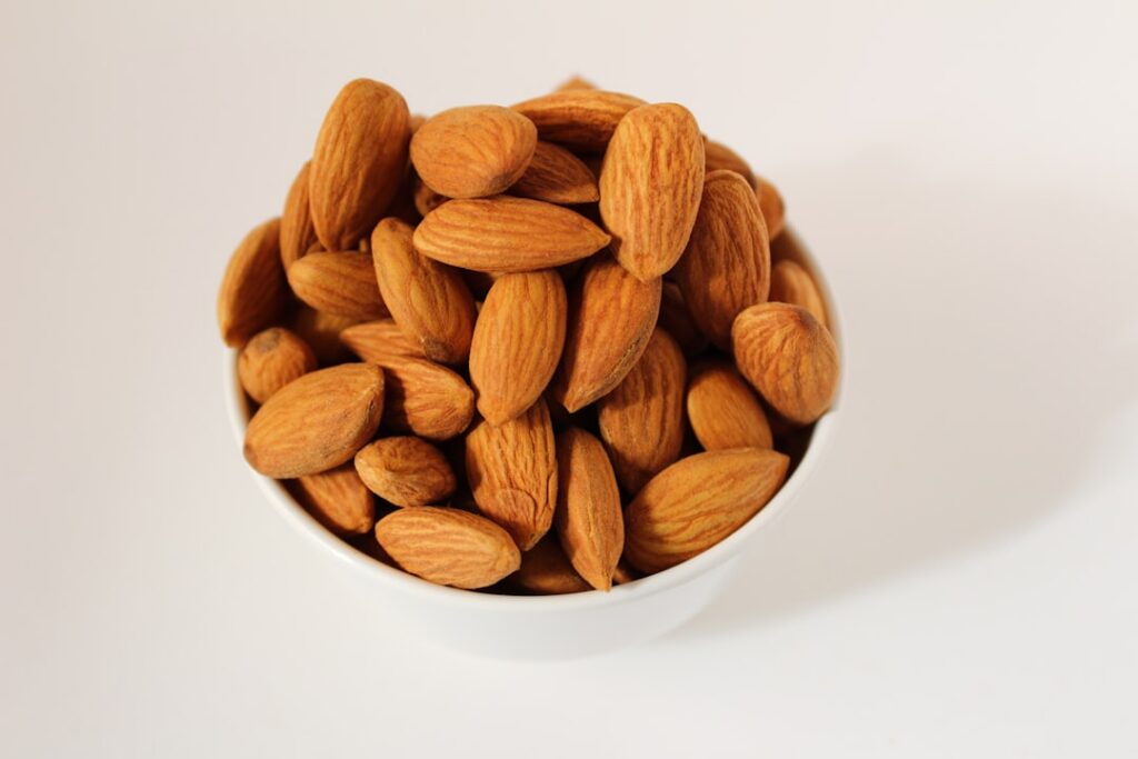 A small pile of about 14-16 whole almonds on a clean surface clearly showing a 100-calorie portion