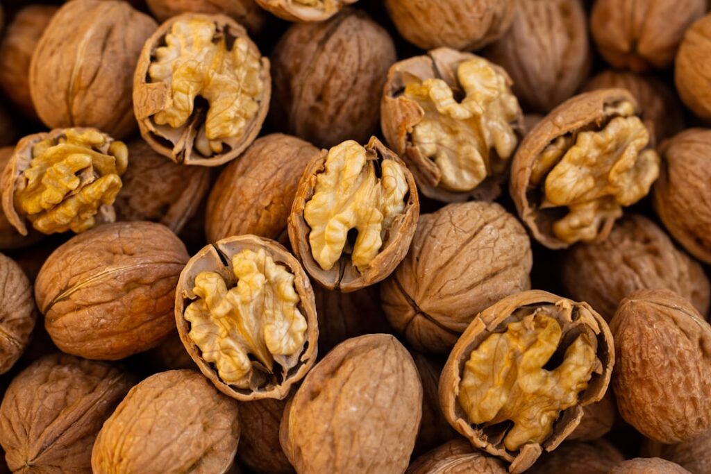 A small pile of about 7 walnut halves on a clean surface clearly showing a 100-calorie portion