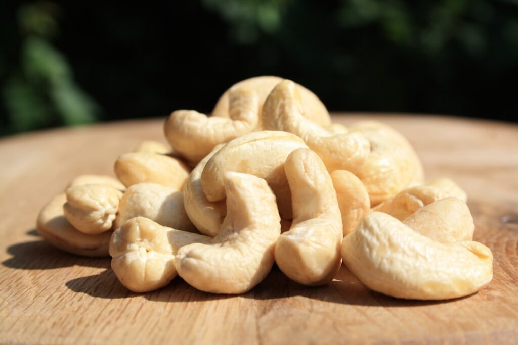 A small pile of about 9-10 whole cashews on a clean surface clearly showing a 100-calorie portion