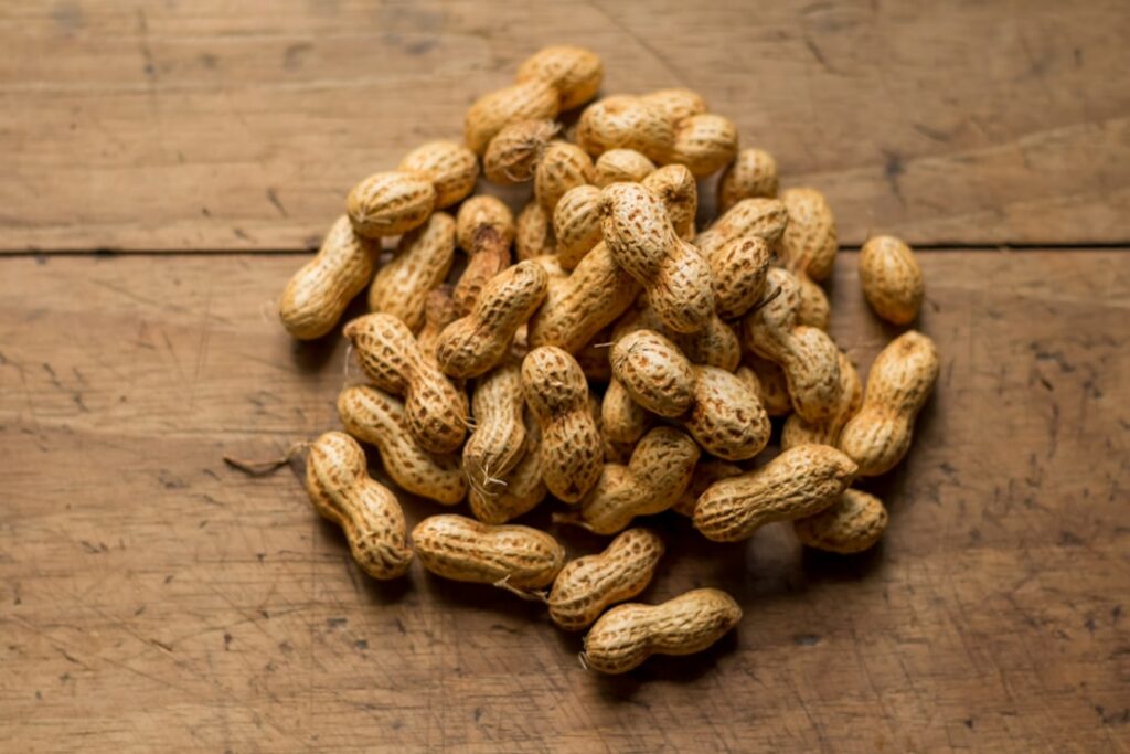 A small pile of about 16-18 shelled peanuts on a clean surface clearly showing a 100-calorie portion