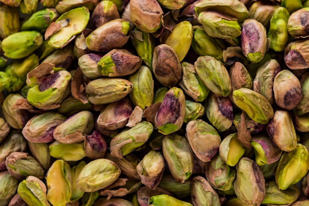 A small pile of about 25-30 shelled pistachios on a clean surface clearly showing a 100-calorie portion