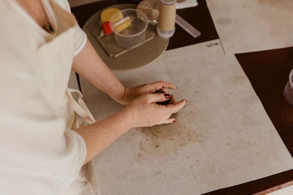 A woman gently applying a small amount of the homemade coffee and Vaseline gel to her cheek demonstrating a patch test o