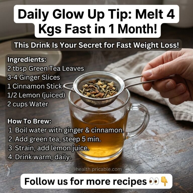 A warm amber-colored drink in a glass mug with a hand holding a tea strainer filled with green tea ginger and cinnamon a