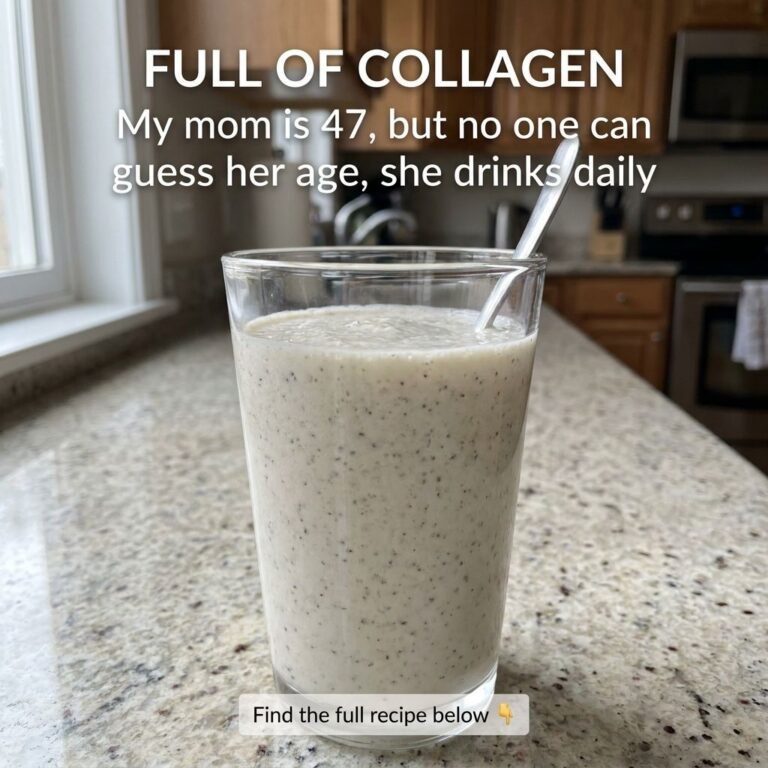 Close-up of a glass filled with a light-colored speckled collagen drink with a spoon on a kitchen countertop
