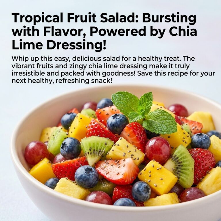 A vibrant bowl of tropical fruit salad with mango pineapple strawberries blueberries kiwi and grapes garnished with mint