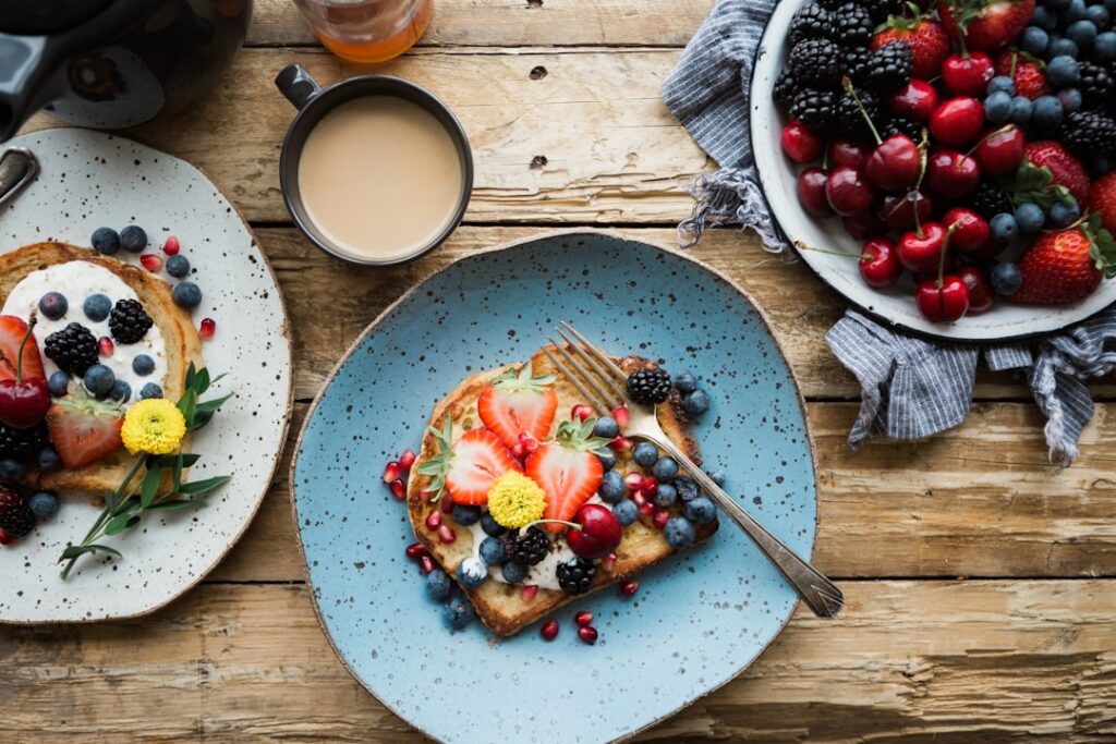 Overhead shot of a vibrant healthy breakfast featuring avocado toast with a perfectly cooked egg a side of fresh berries