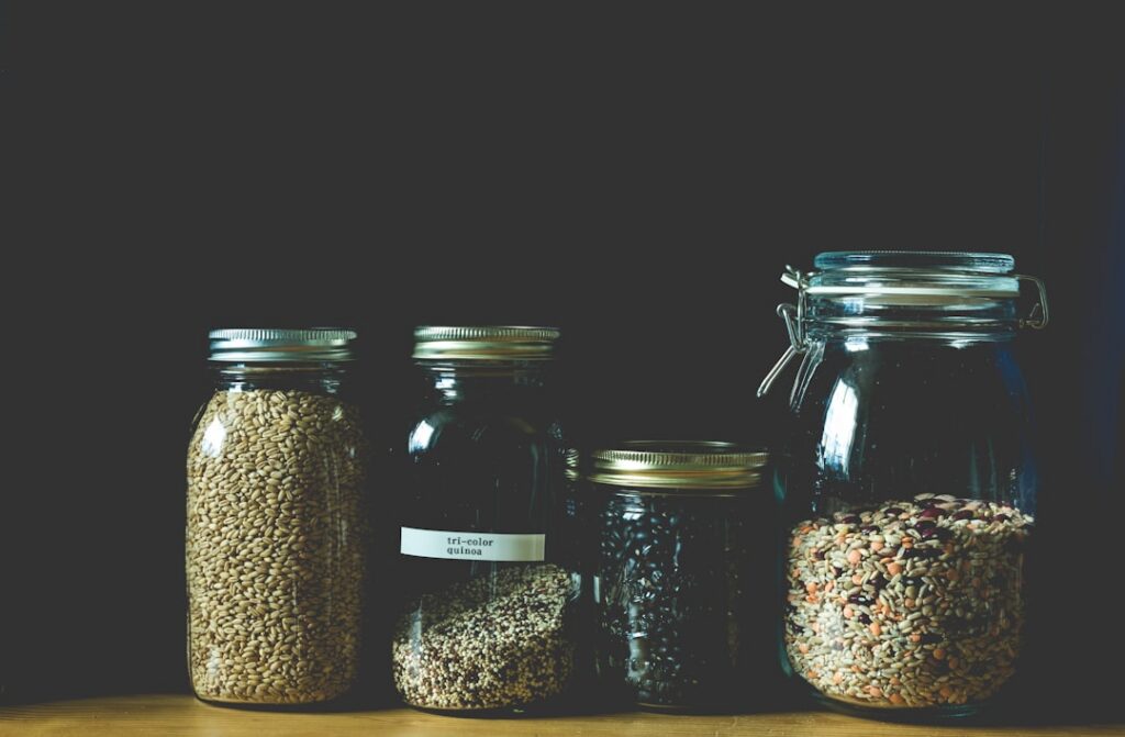 A close-up of various seeds soaking in small glass jars or containers illustrating different sizes and colors of seeds s
