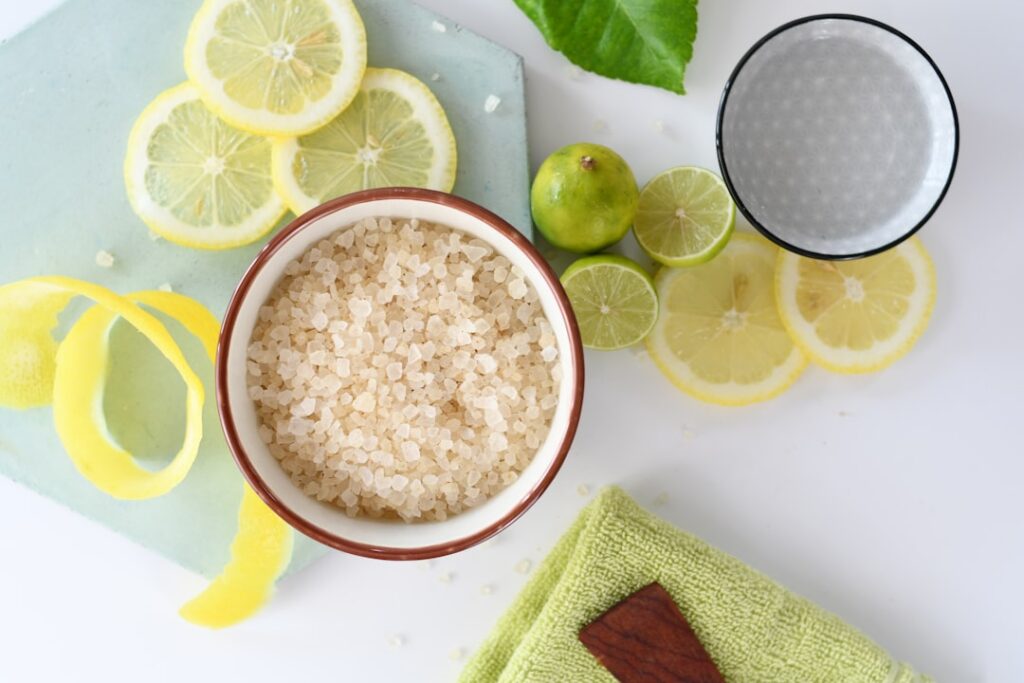 Ingredients for a natural skin brightening scrub including brown sugar lemon and coconut oil