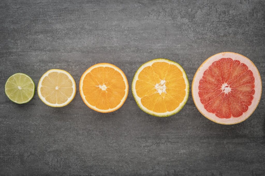 A variety of colorful fresh healthy foods like fruits vegetables and probiotics laid out on a clean surface emphasizing 