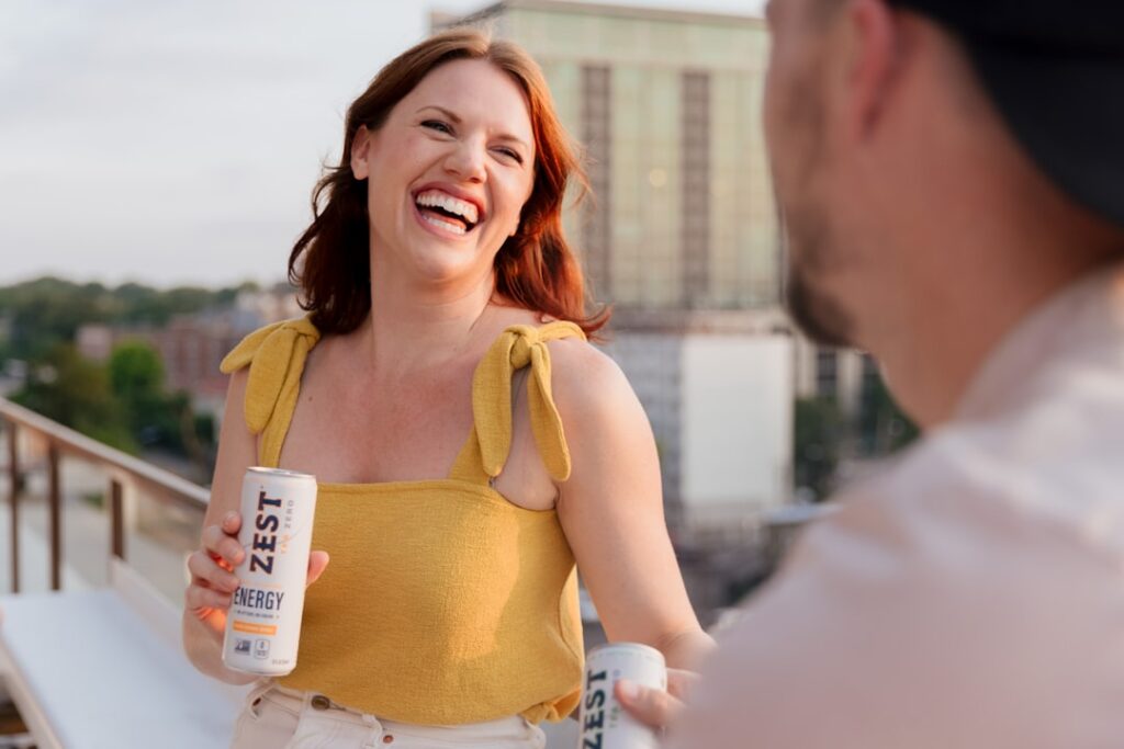 A person holding a glass of a light yellow liquid representing the detox blend with a serene and healthy expression
