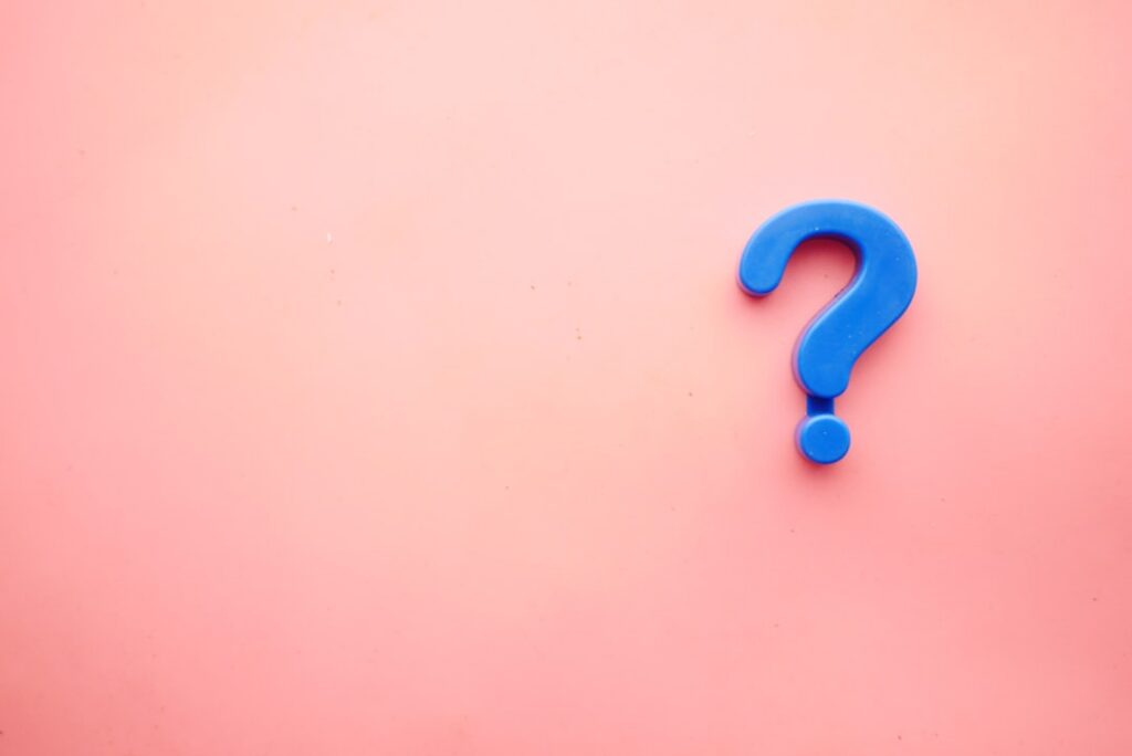 A person looking thoughtful or solving a puzzle with a lightbulb icon or question mark over their head representing a br