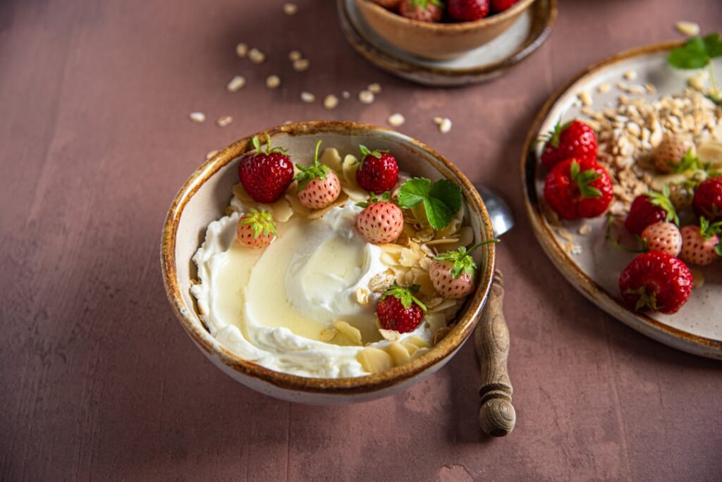A vibrant spread of healthy toppings suitable for both Greek yogurt and cottage cheese including fresh fruits various nu