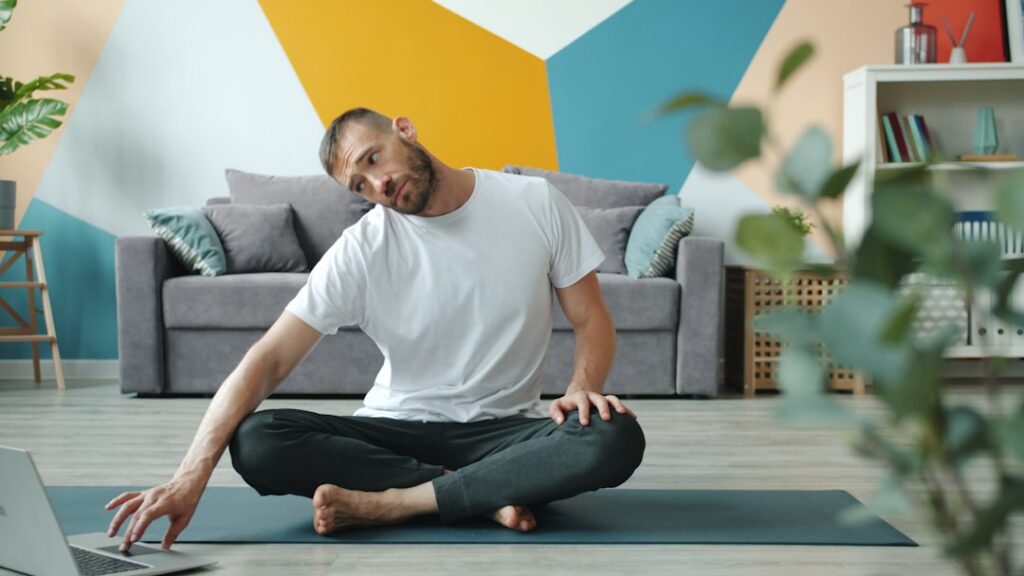 A person happily exercising in their living room demonstrating a simple bodyweight squat The room is tidy and well-lit