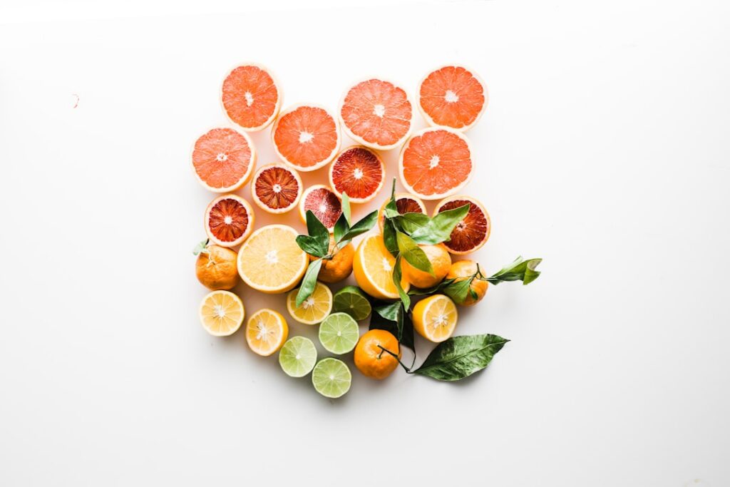 Various fresh ingredients for a beauty drink laid out on a kitchen counter mixed berries spinach chia seeds a lemon and