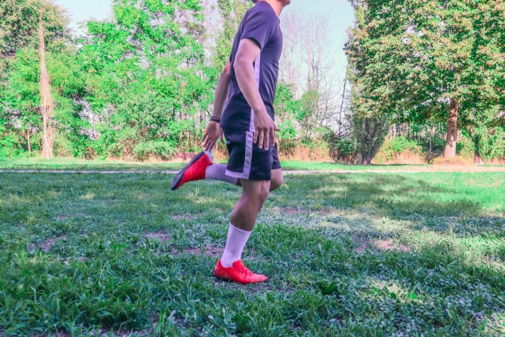 A person performing bodyweight standing calf raises focusing on proper form with a slight pause at the top