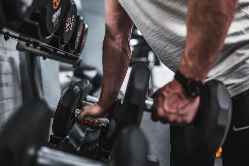 A person performing a dumbbell bicep curl with good form illustrating arm workout
