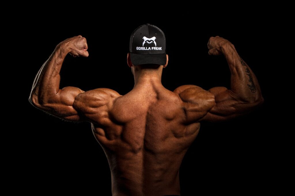 A person performing an overhead dumbbell tricep extension showcasing the arm muscles