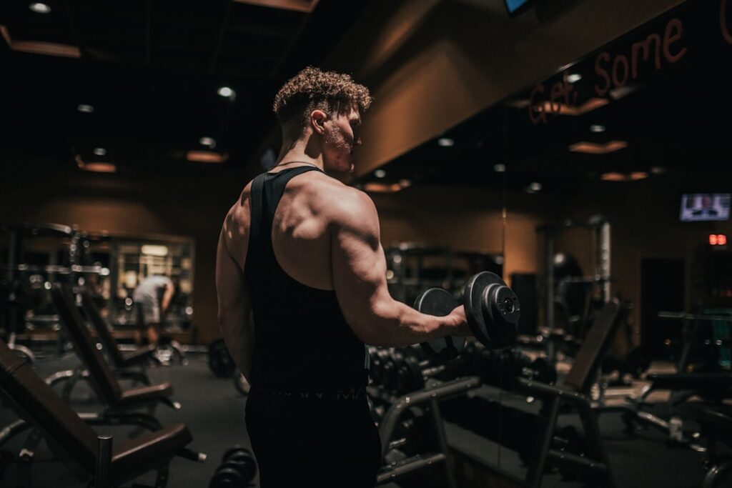 A person performing dumbbell lateral raises with good form focusing on shoulder definition