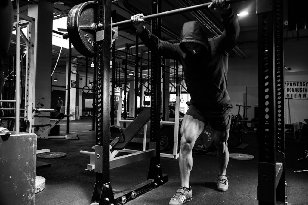 A person performing a deep bodyweight squat with good form demonstrating strong leg and glute activation