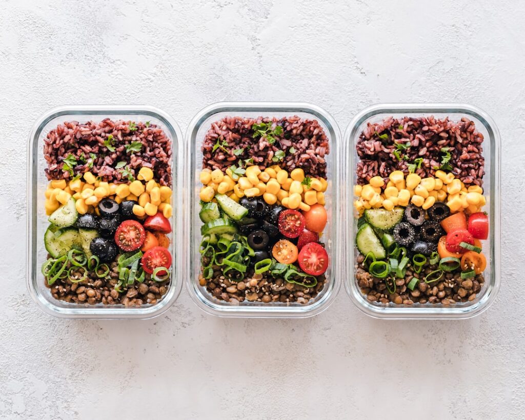 A variety of healthy gut-friendly meals prepped and stored in glass containers showcasing colorful vegetables grains and