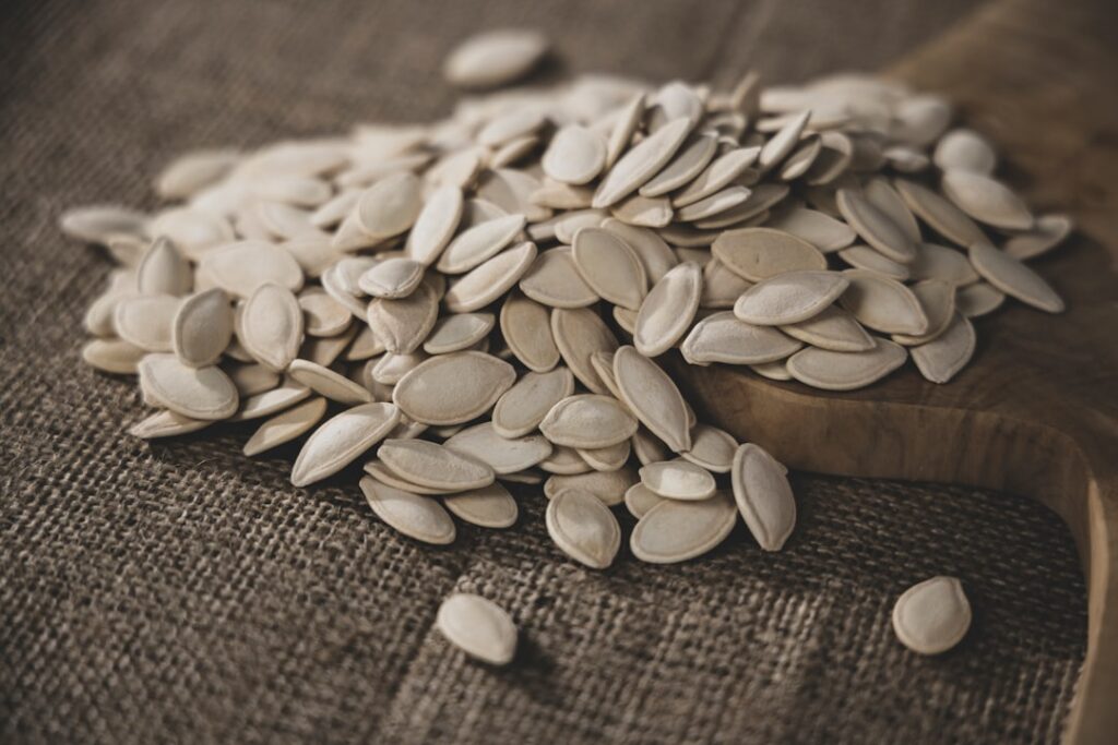 A close-up shot of a handful of roasted pumpkin seeds