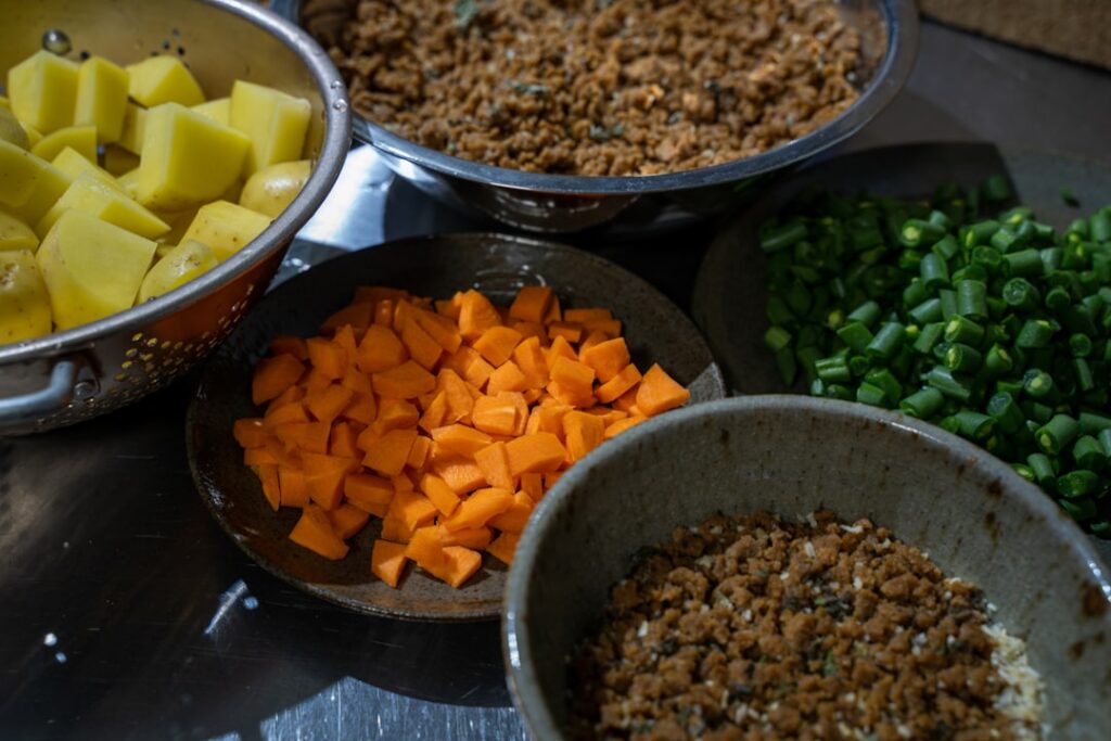 A vibrant flat lay of various plant-based ingredients prepped in different ways cubed tofu sliced mushrooms diced bell p