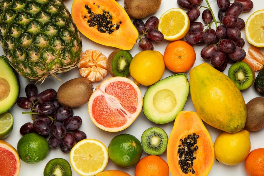 A vibrant array of fresh fruits and vegetables commonly used in healthy juices and teas such as berries leafy greens car