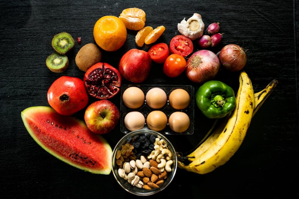 A vibrant flat lay of various potassium-rich foods such as bananas avocados spinach sweet potatoes and kidney beans arra