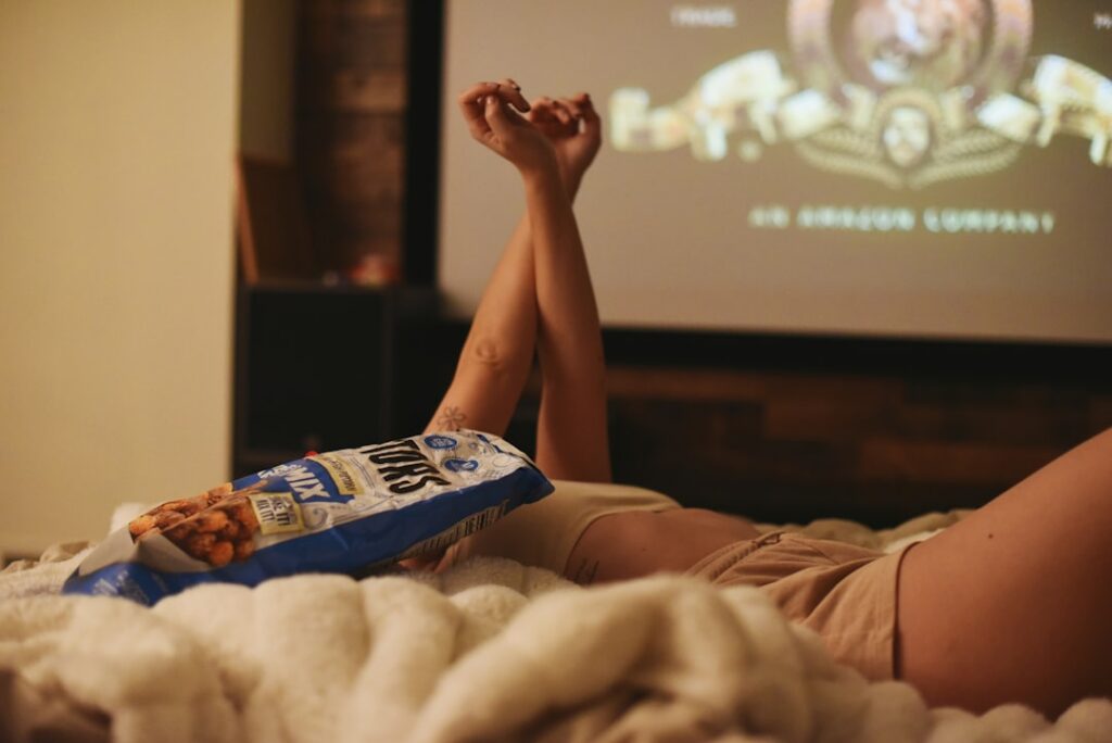 A variety of sleep-promoting evening snacks laid out attractively such as bananas almonds a cup of chamomile tea a small